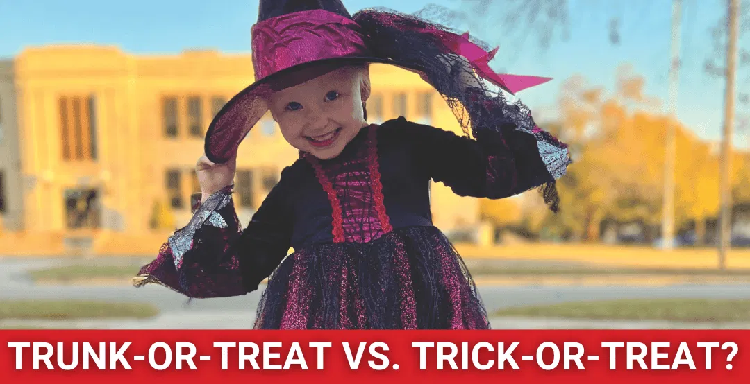 Little girl in black witch costume in neighborhood