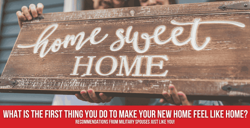 Couple holding a wooden sign reading, "Home Sweet Home"