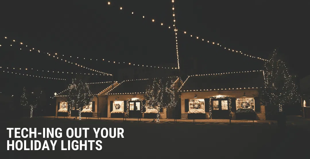 A series of houses strung up with Christmas lights