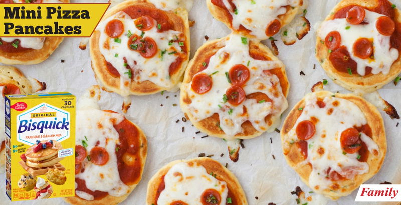 Mini pizza pancakes laid on a tray with a box of Bisquick pancake mix on top of the photo