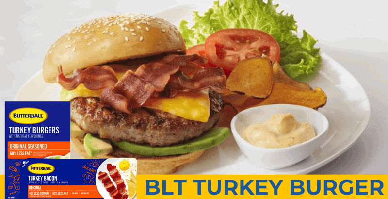 A turkey burger with turkey bacon on a bun, sitting on a plate with lettuce, tomatoes, chips and dip